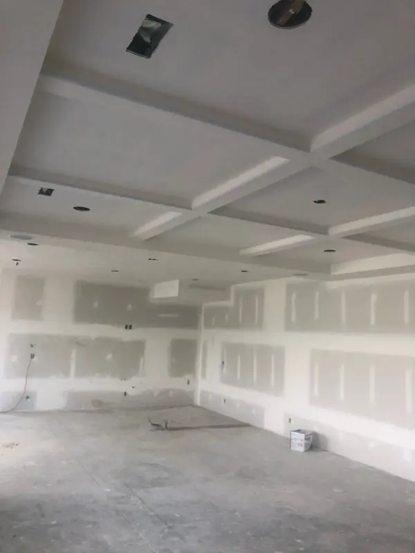Open plan room with drywall hung, taped and sanded ready for paint