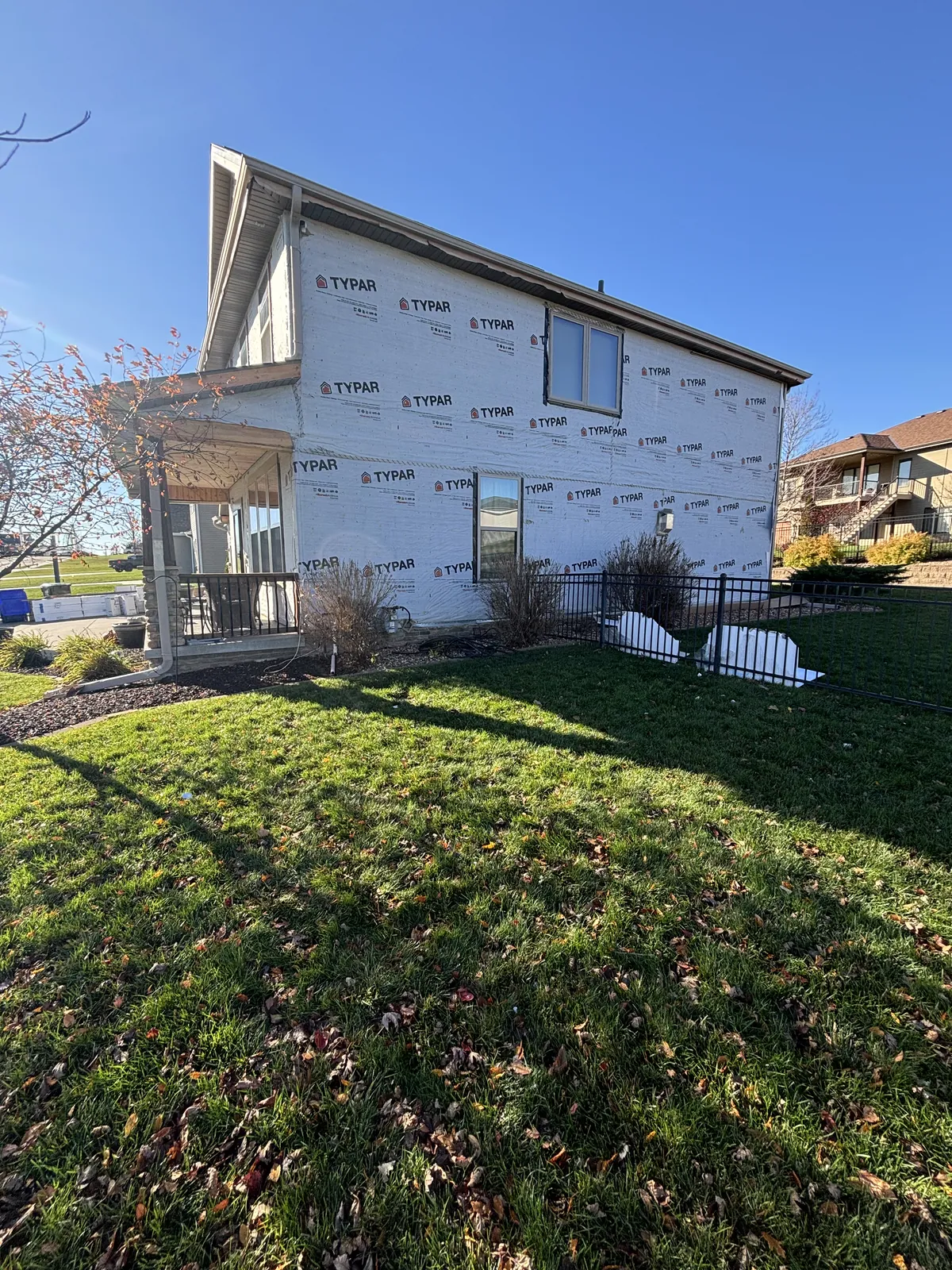 Large two story home covered in branded house wrap ready for siding