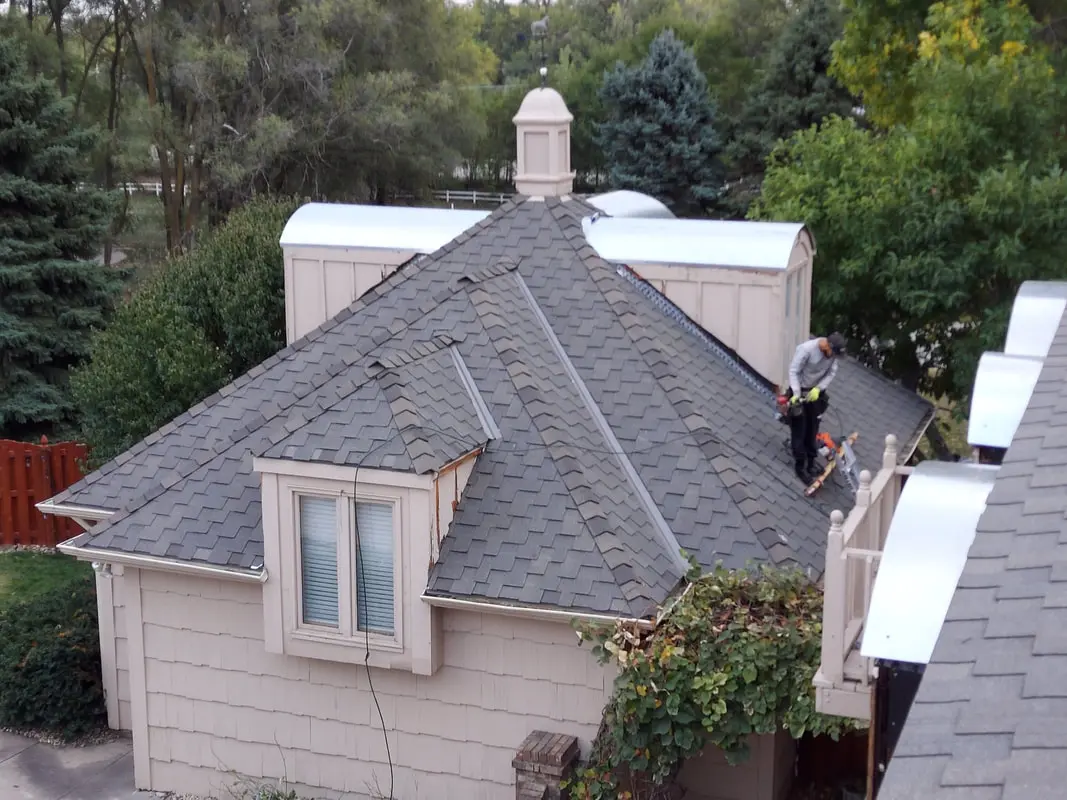 Finished gray presidential shingle roof on a two story home with dormers and a cupola