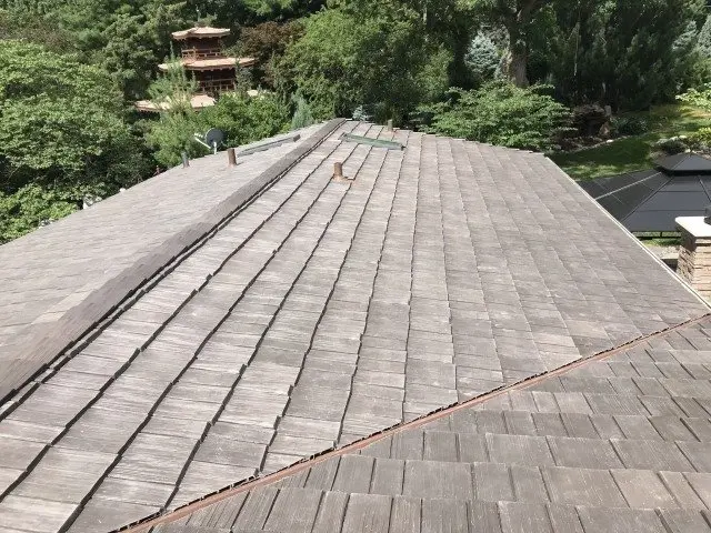 Cedar shake roof laid over a hip and valley on a large house